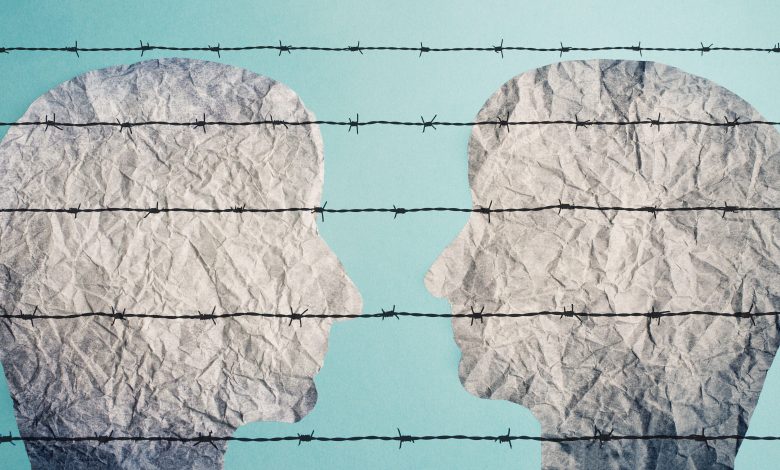 An illustrtion of two faces looking at each other behind a barbed fence, 14 October 2021.Berit Kessler/ Alamy via Rueters.